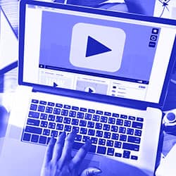 Laptop user watching Accutive Security insights and informative videos on a video player.